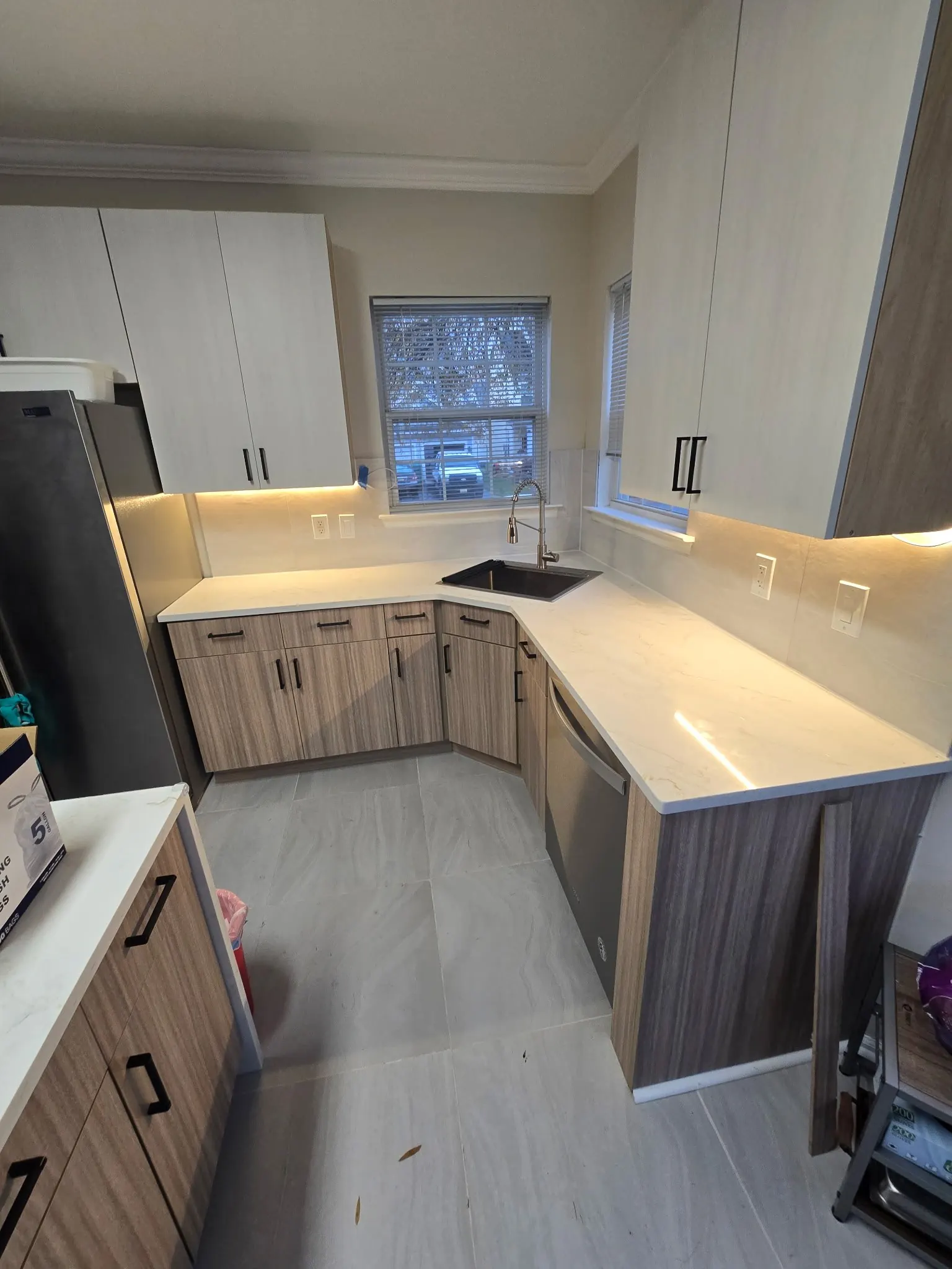 Kitchen counters and under-cabinet lighting installed.