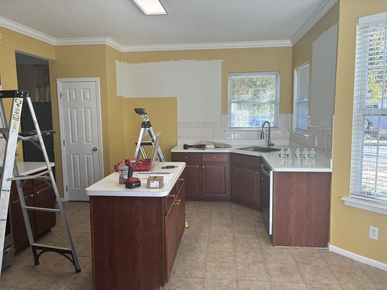 Kitchen with upper cabinets removed and lower cabinets remaining.