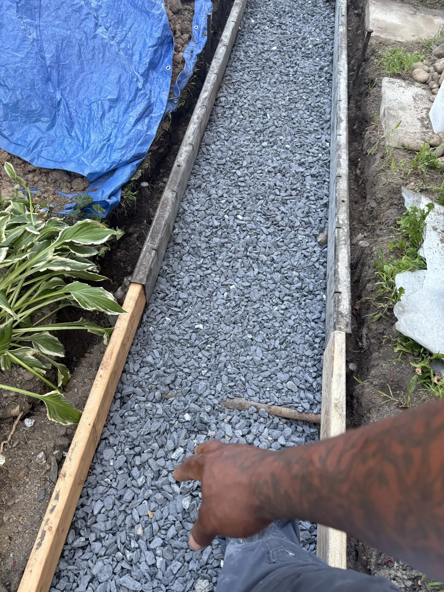 Timber forms holding a crushed-stone base for the path.