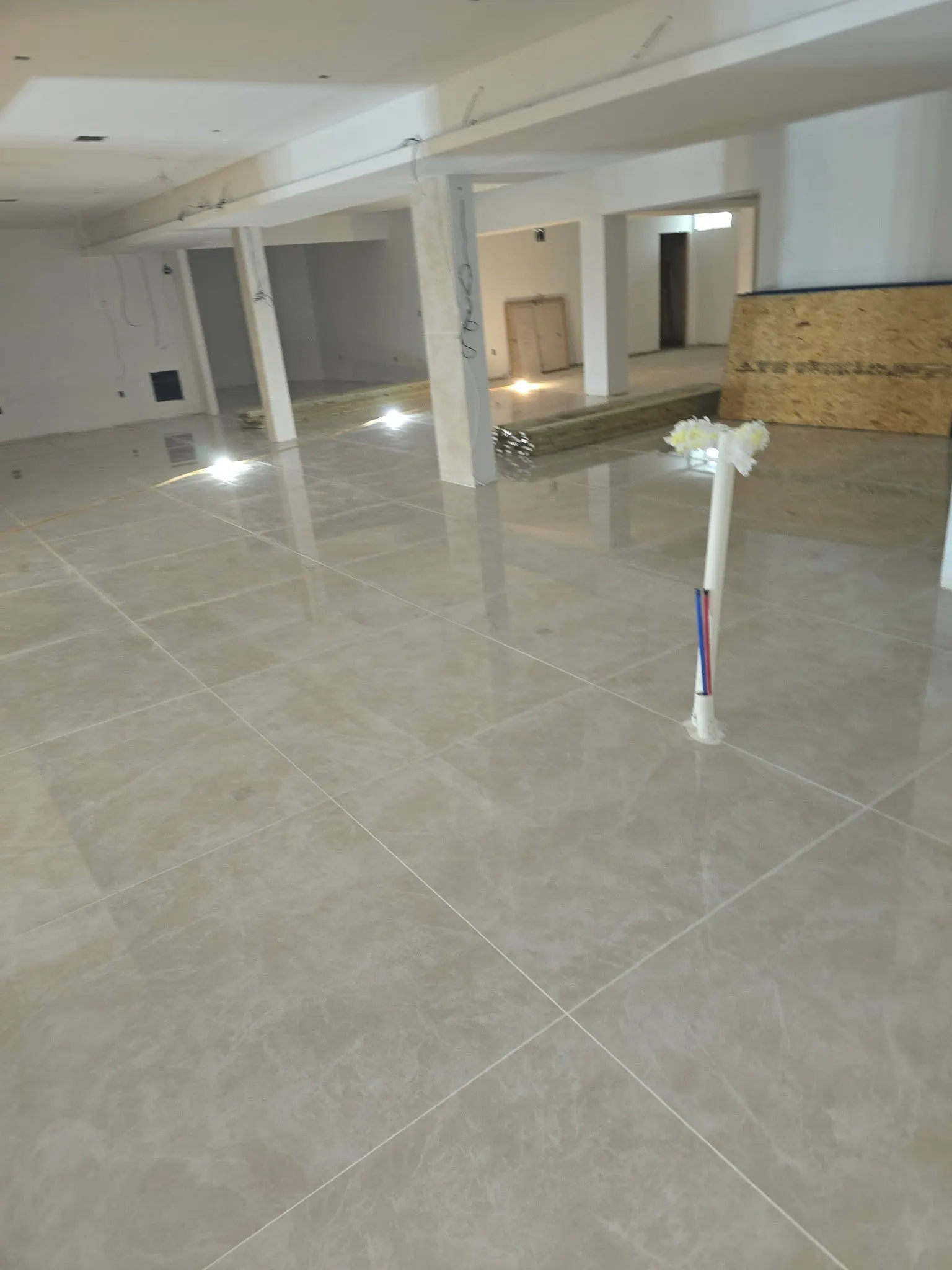 Interior with tile flooring and unfinished ceiling areas.