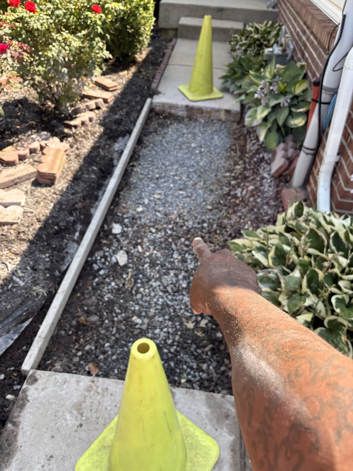 Aggregate base between retained concrete walkway sections.